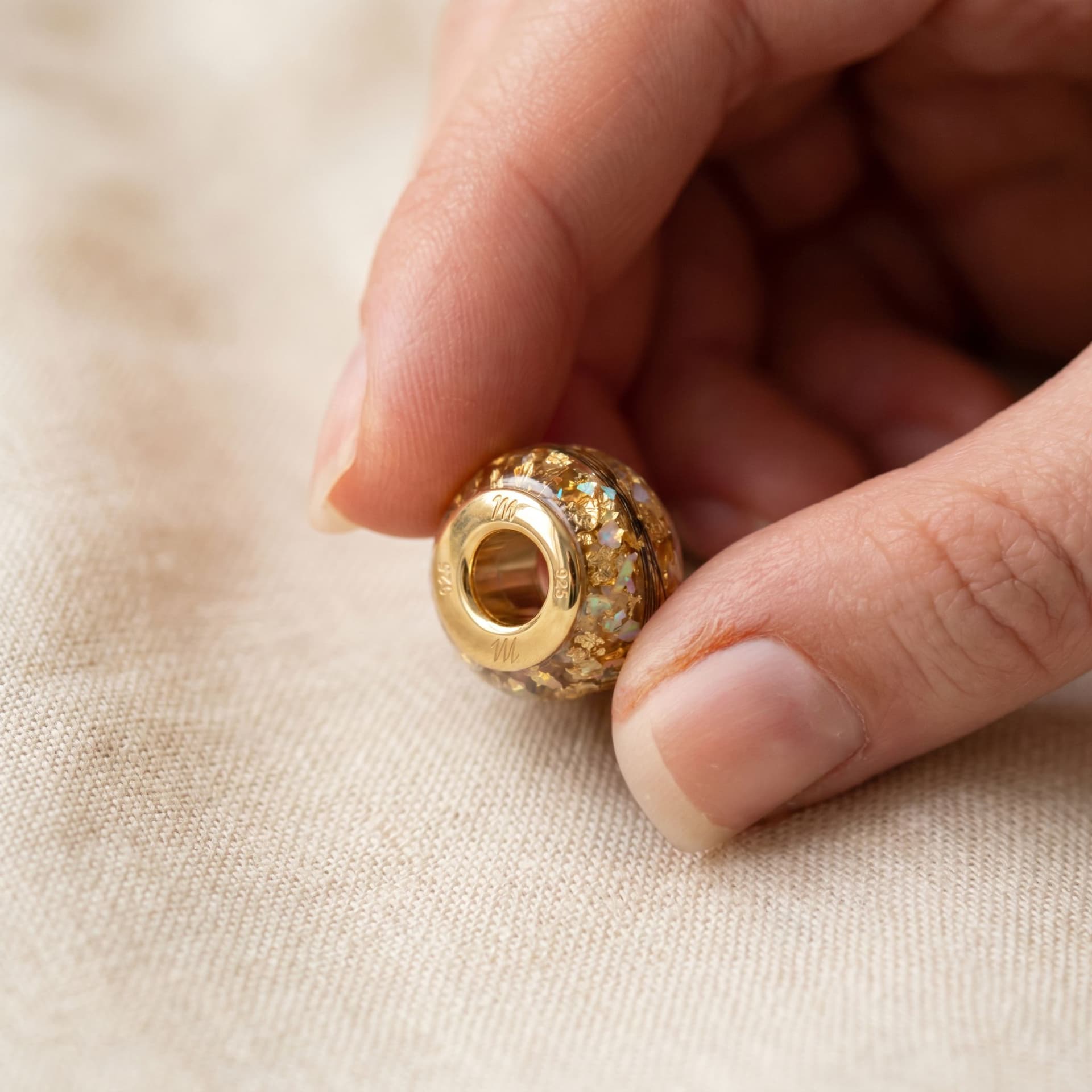 Pandora Charm with Ashes (14K Gold) - held in hand