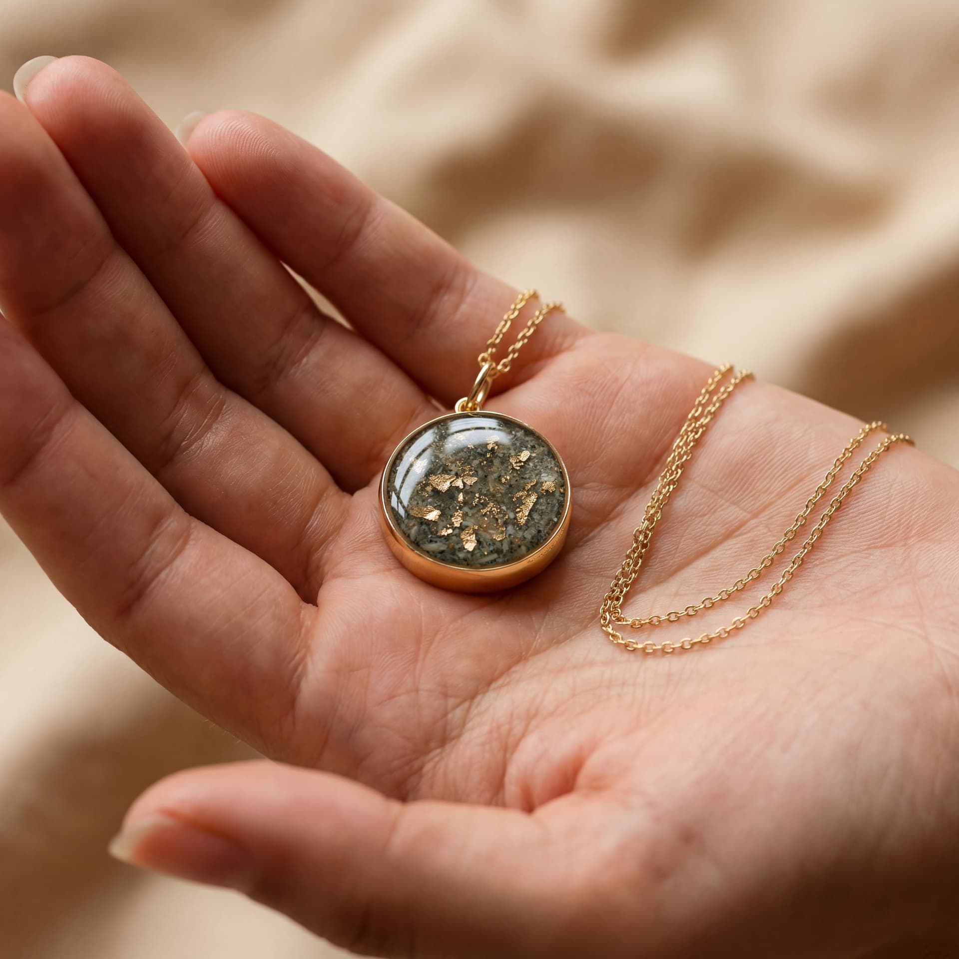 Circle of Life Pendant with Ashes (18 mm) - held in hand
