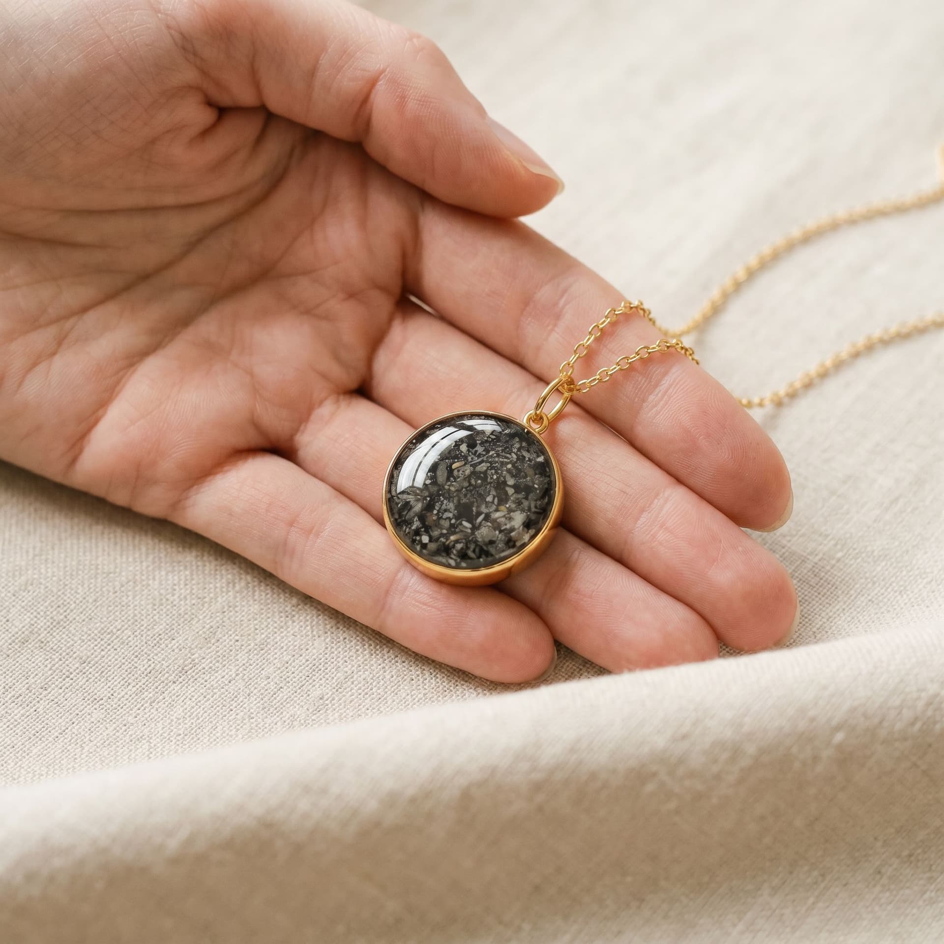 Circle of Life Necklace with Custom Ashes Arrangement (18 mm, 14K Gold) - held in hand