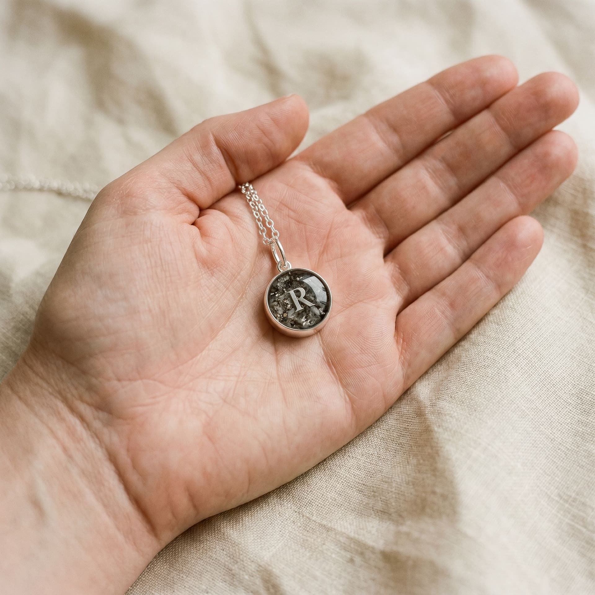 Circle of Life Pendant with Ashes (12 mm) - held in hand