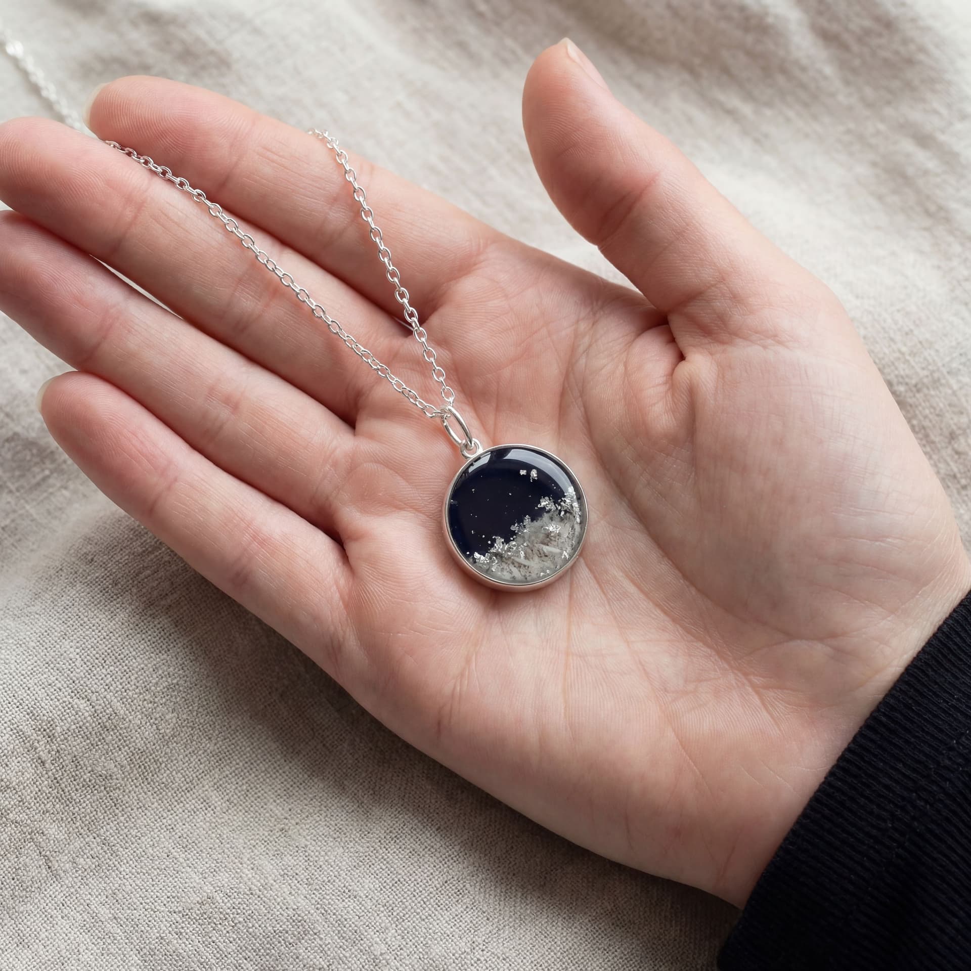 Circle of Life Pendant with Ashes, Night Edition (18 mm) - held in hand