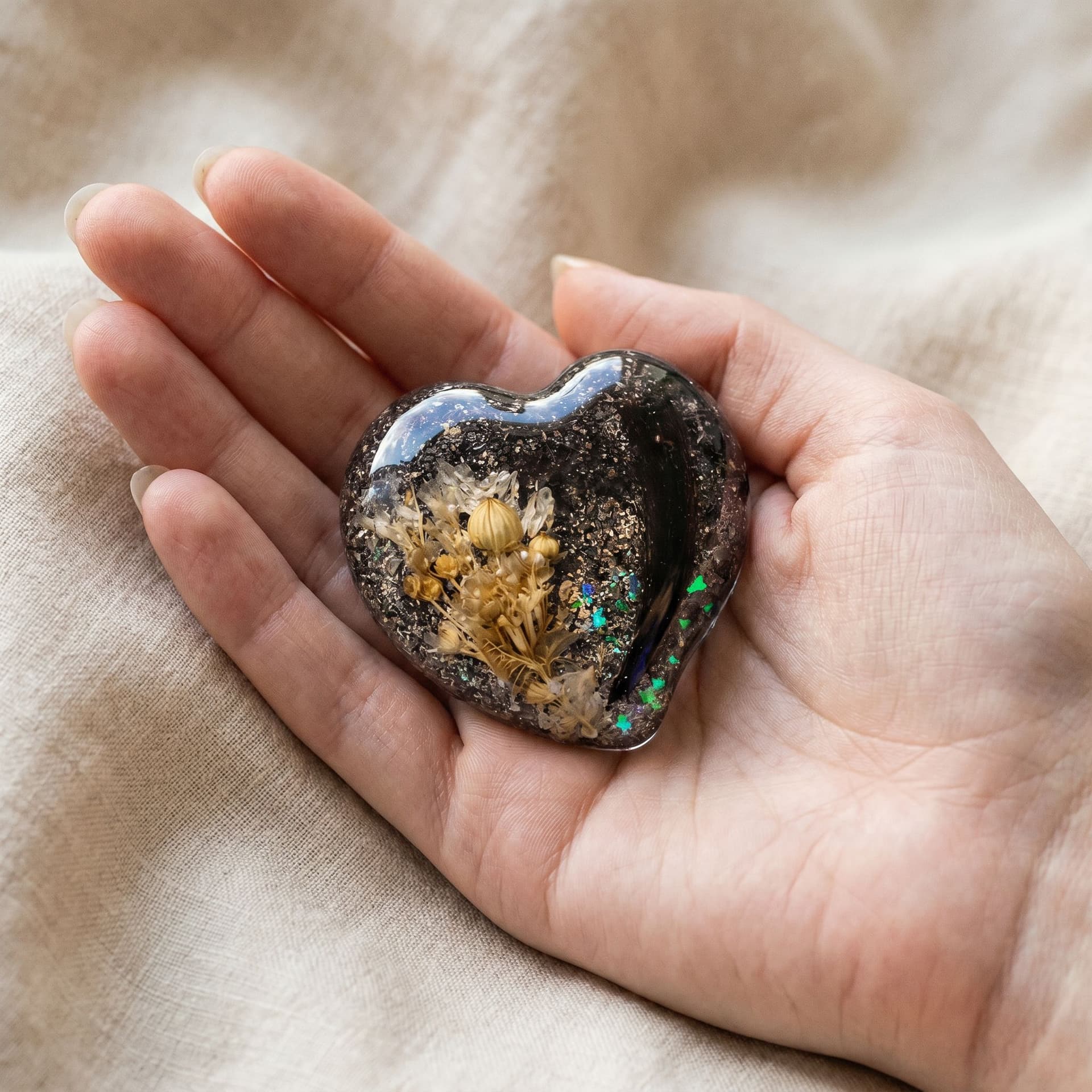 Heart Memory Stone with Ashes - held in hand, second view