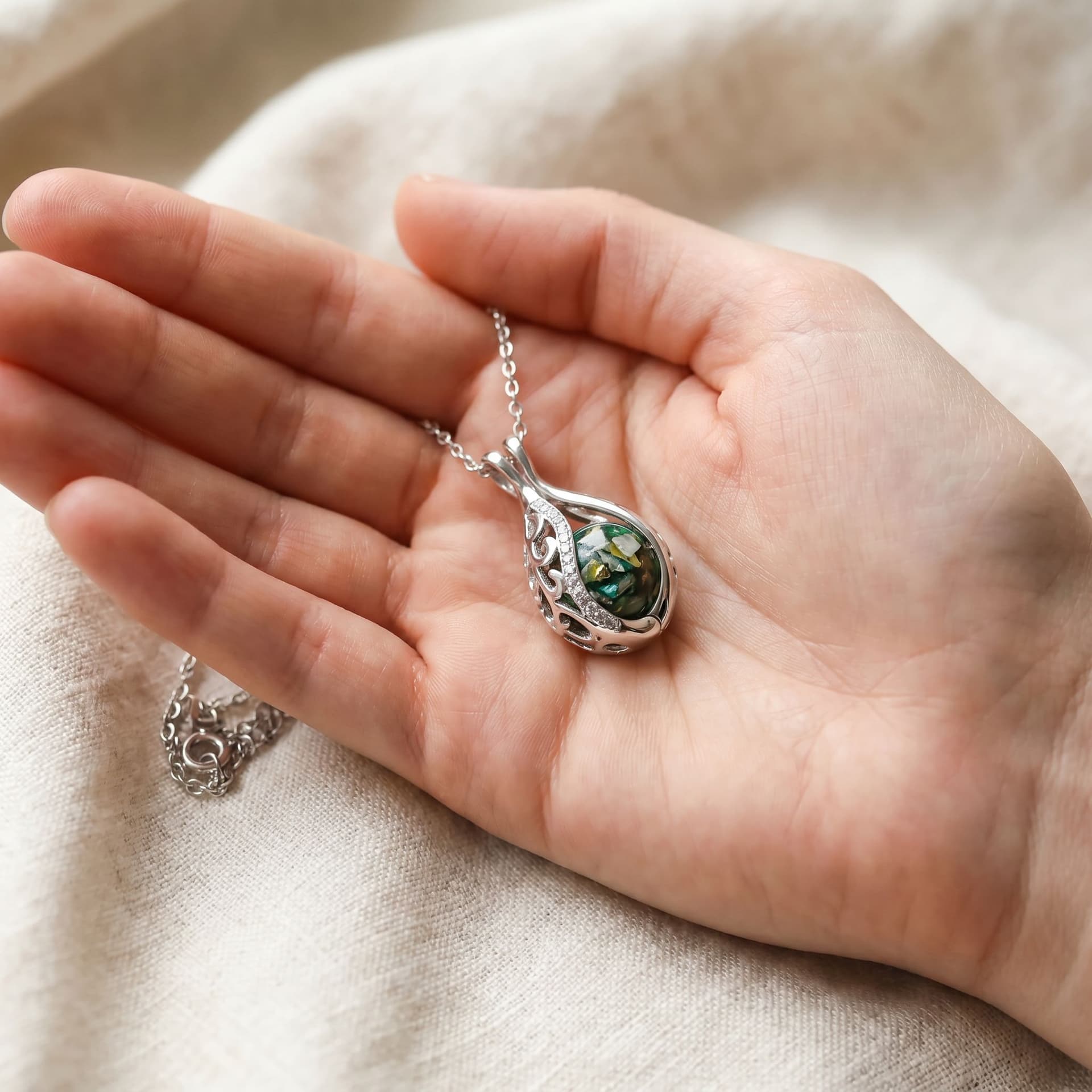 Teardrop Necklace with Ashes - held in hand, second view