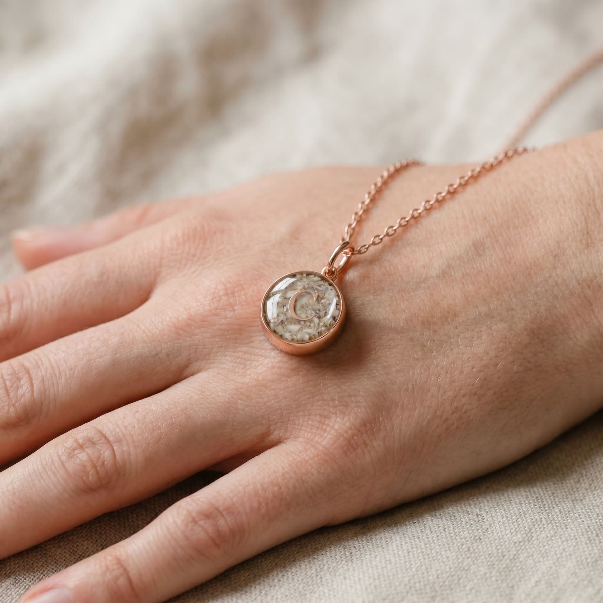 Circle of Life Pendant with Ashes (12 mm) - held in hand, second view