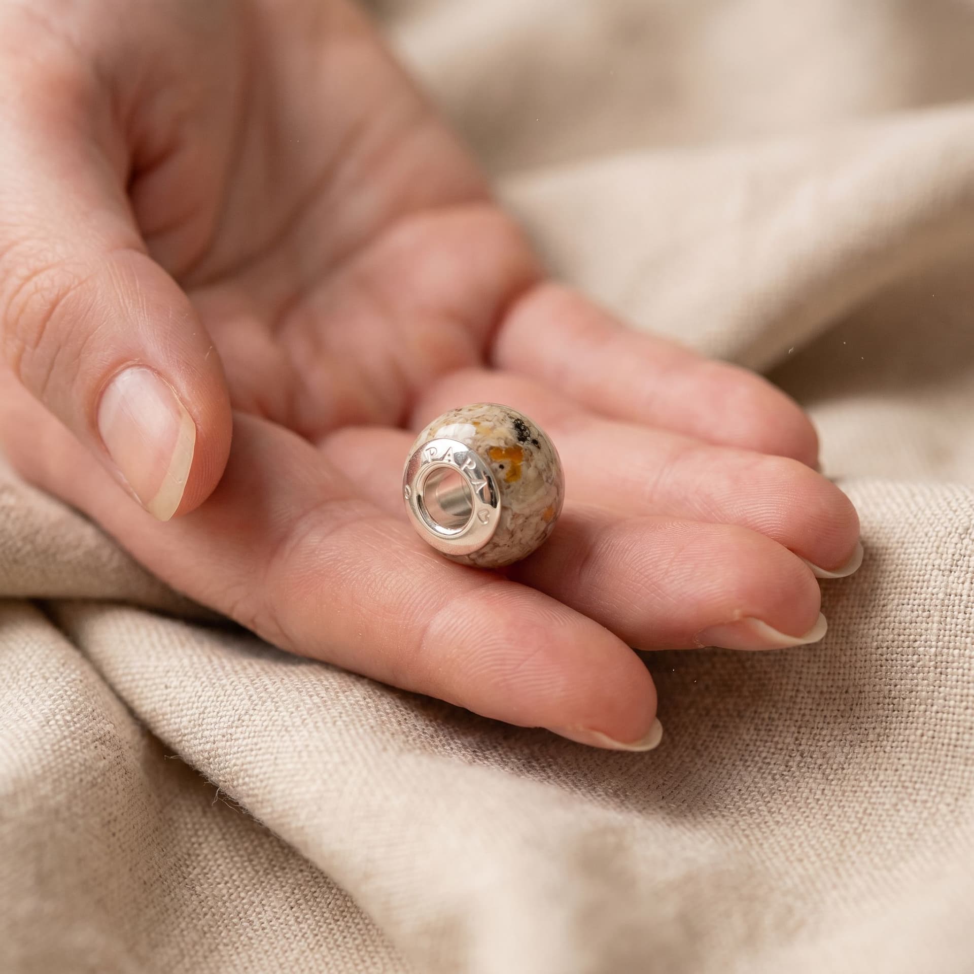 Pandora Charm with Ashes - held in hand, second view