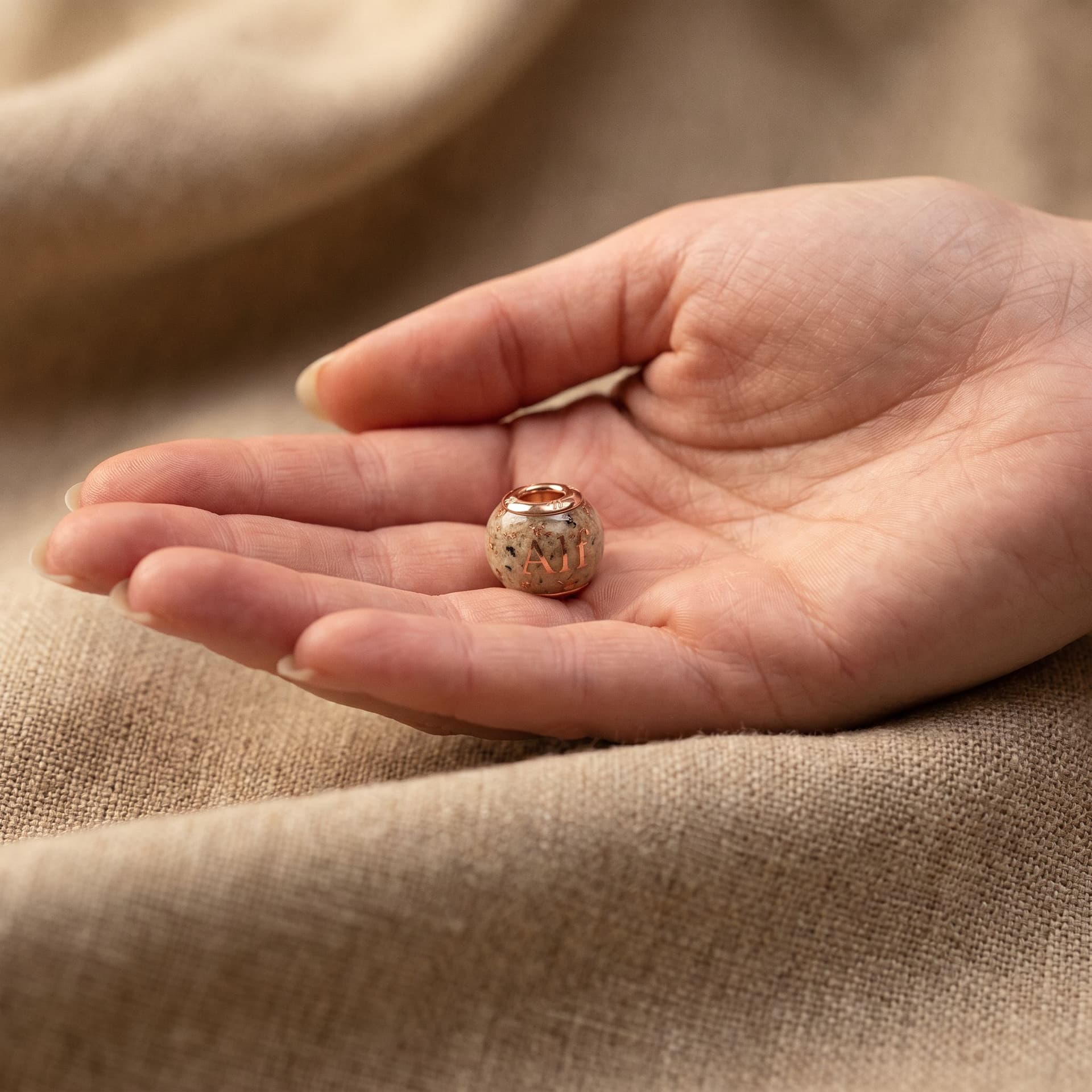 Pandora Charm with Ashes & Pet Name - held in hand, second view